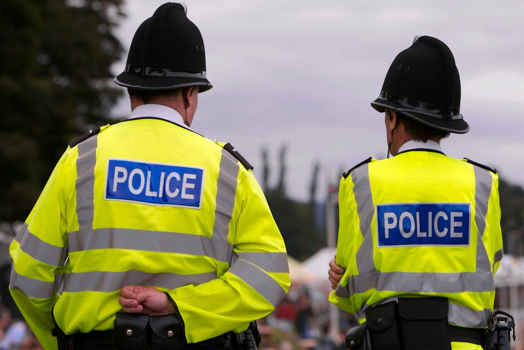 The back of police officers wearing helmets